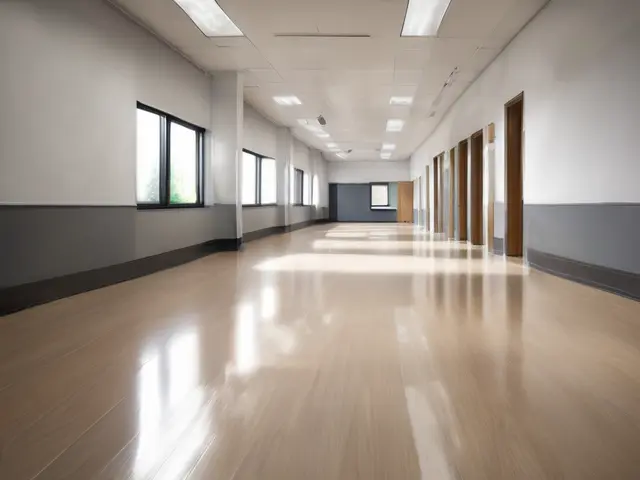 A clean commercial corridor with polished floors and daylight from the windows.